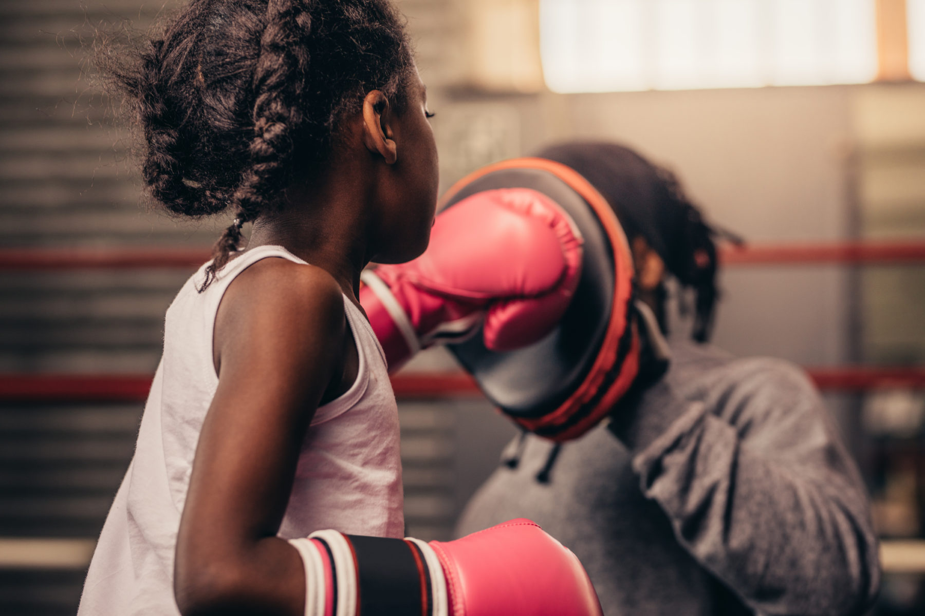 rear-view-of-a-boxing-kid-practicing-her-punches