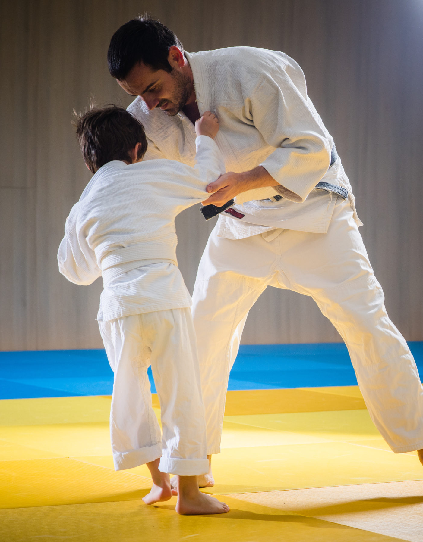 man-and-young-boy-are-training-judo-throw